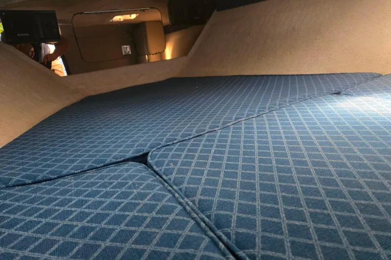 Slide: The Image of Interior cabin of 1987 Sea Ray Pachanga 22 with blue patterned cushions. - 24