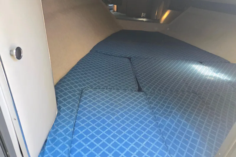 Slide: The Image of Interior cabin of 1987 Sea Ray Pachanga 22 with blue patterned cushions. - 25