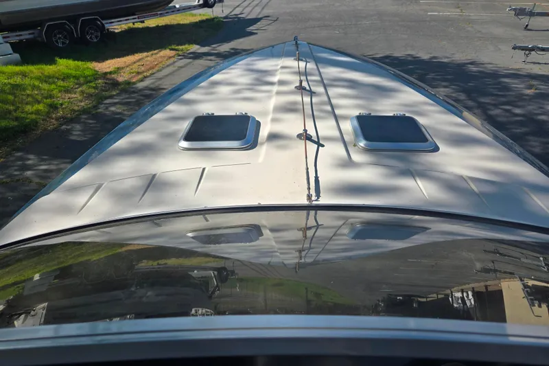 Slide: The Image of 1987 Sea Ray Pachanga 22 boat deck with hatches, parked on pavement. - 29