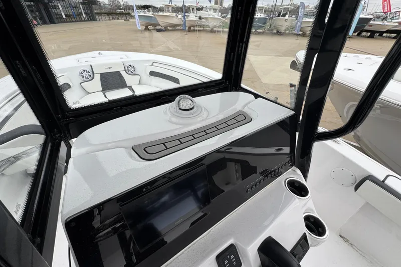 Slide: The Image of 2026 Tidewater 220 LXF boat interior with modern dashboard and seating. - 11