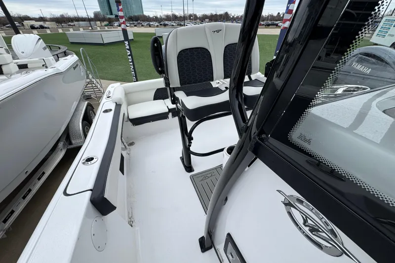 Slide: The Image of 2026 Tidewater 220 LXF boat interior with seating and console details. - 18