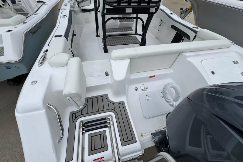 Slide: The Image of 2026 Tidewater 220 LXF boat interior with seating and motor, showcasing modern design. - 4
