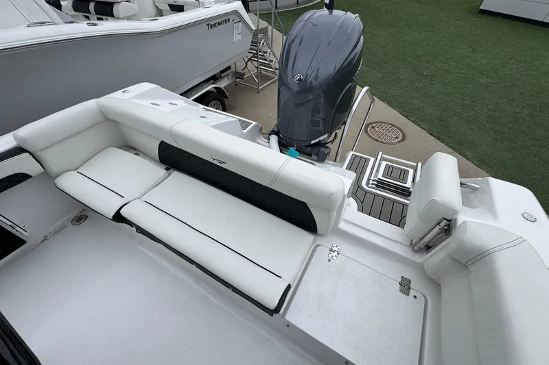 Slide: The Image of 2026 Tidewater 220 LXF boat interior with white seating and outboard motor. - 5