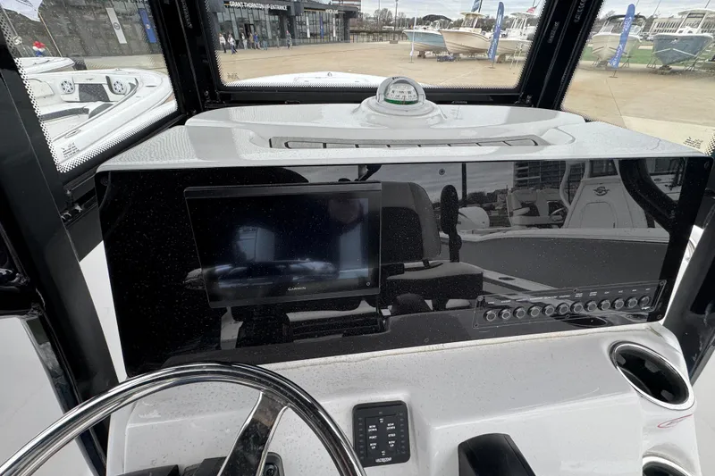 Slide: The Image of 2026 Tidewater 220 LXF boat dashboard with Garmin display and control panel. - 9