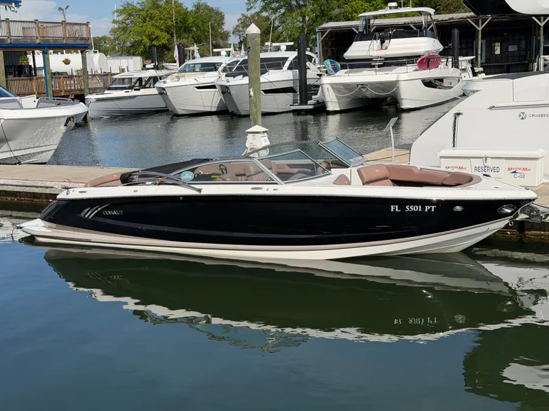 Slide: The Image of 2013 Cobalt A28 boat docked beside a larger yacht. - 0