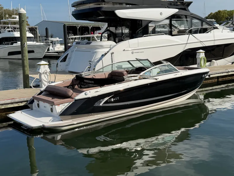 Slide: The Image of 2013 Cobalt A28 boat docked in marina, sleek and modern. - 2