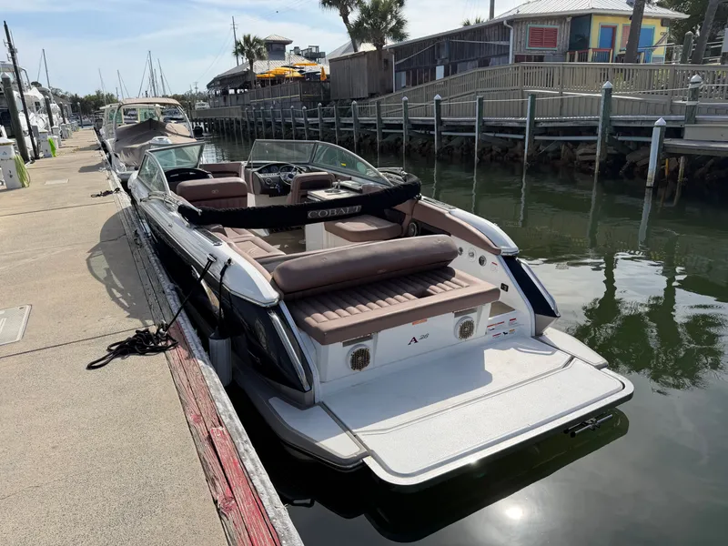 Slide: The Image of 2013 Cobalt A28 boat docked on a sunny day. - 4