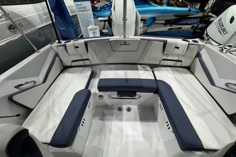 Slide: The Image of 2026 Stingray 20 SBX boat interior with white and navy seating, showcasing spacious design. - 1