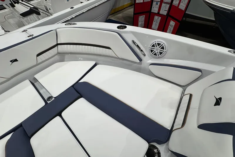 Slide: The Image of Interior of 2026 Stingray 20 SBX boat with white and navy seating. - 10