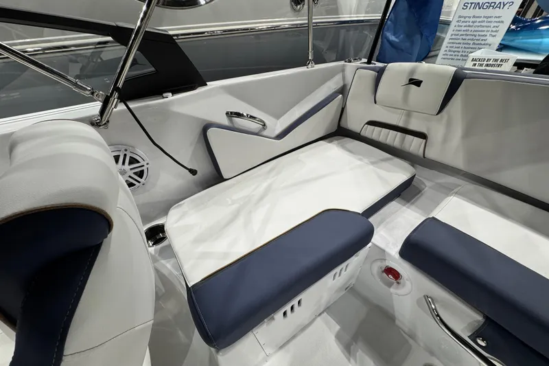 Slide: The Image of 2026 Stingray 20 SBX boat interior with white and navy seating, showcasing modern design. - 14