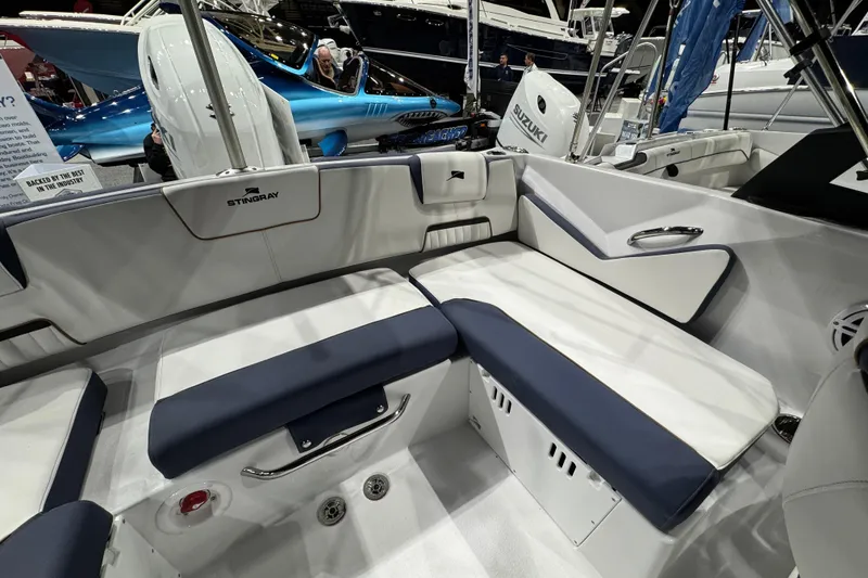 Slide: The Image of Interior of 2026 Stingray 20 SBX boat with white and navy seating. - 15