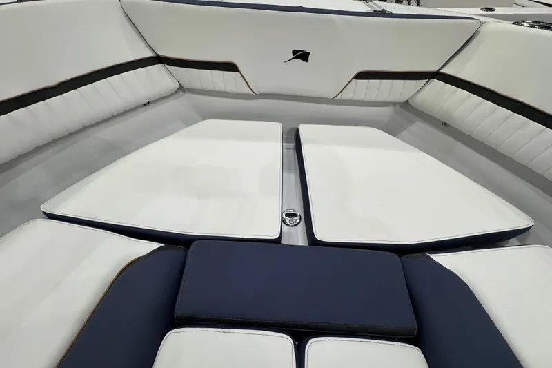 Slide: The Image of 2026 Stingray 20 SBX boat interior with white and navy cushioned seating. - 18
