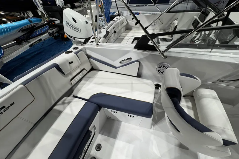 Slide: The Image of 2026 Stingray 20 SBX boat interior with white and blue seating, Suzuki engine visible. - 6