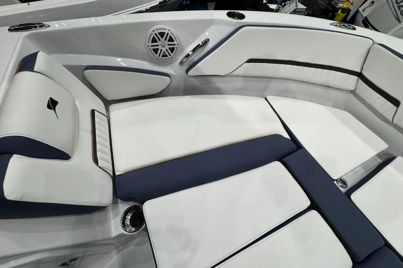 Slide: The Image of 2026 Stingray 20 SBX boat interior with white and navy seating, featuring sleek design elements. - 9