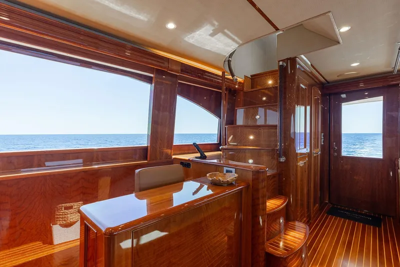 Slide: The Image of Luxurious interior of 2016 Viking 82 Sky Bridge yacht with polished wood finish and ocean view. - 15