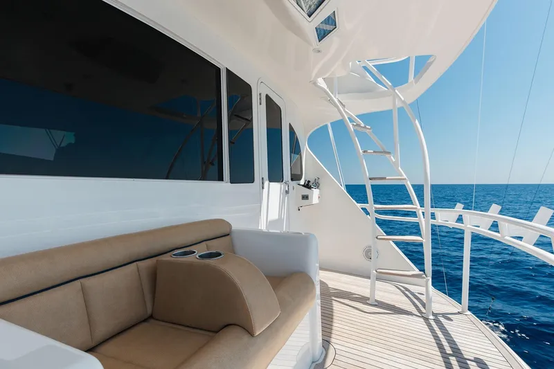 Slide: The Image of Luxurious 2016 Viking 82 Sky Bridge yacht deck with seating and ocean view. - 22