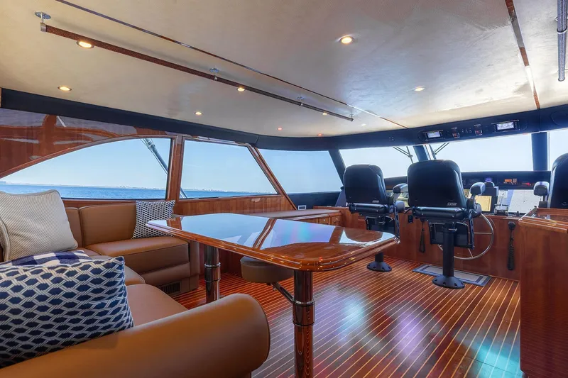 Slide: The Image of Luxurious interior of 2016 Viking 82 Sky Bridge yacht with plush seating and polished wood finishes. - 28