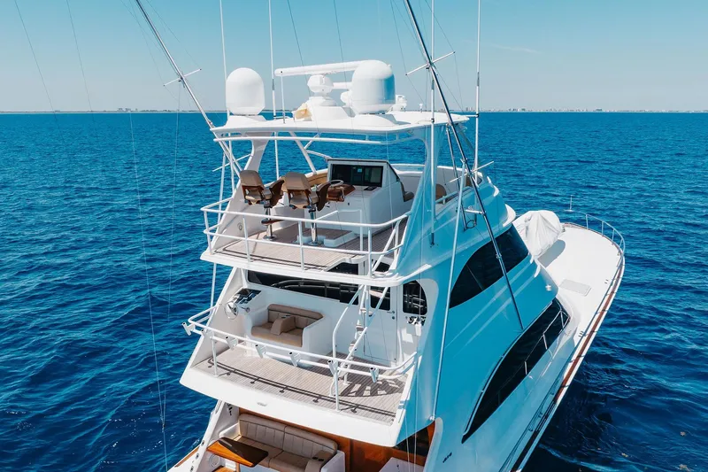 Slide: The Image of Luxurious 2016 Viking 82 Sky Bridge yacht cruising on open blue sea. - 5