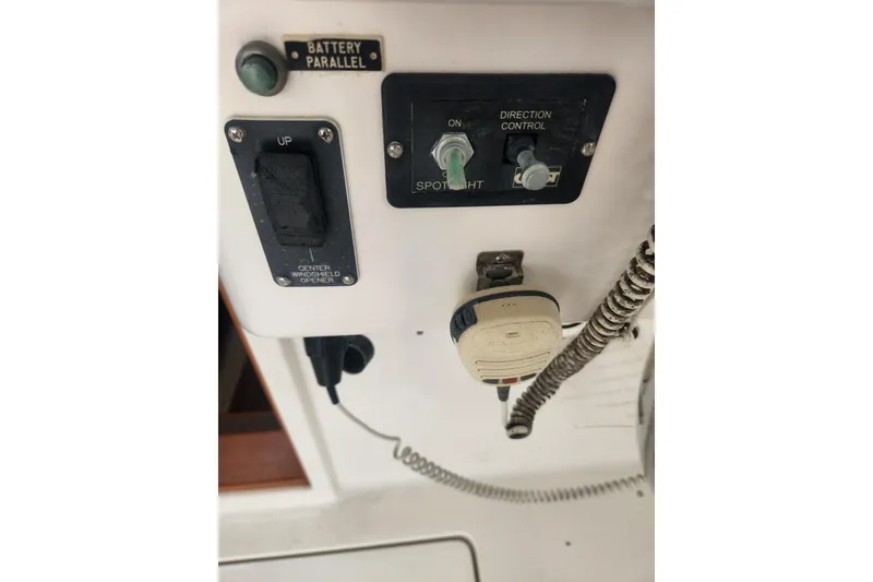 Slide: The Image of Control panel of a 2004 Legacy 28ft boat with spotlight and radio. - 12