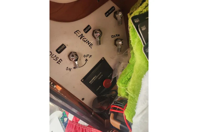 Slide: The Image of Control panel of a 2004 Legacy 28ft boat with labeled switches and dials. - 18