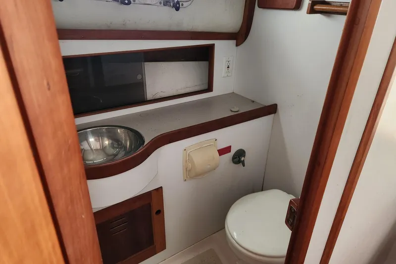 Slide: The Image of 2004 Legacy 28ft boat bathroom with sink, toilet, and wooden accents. - 20