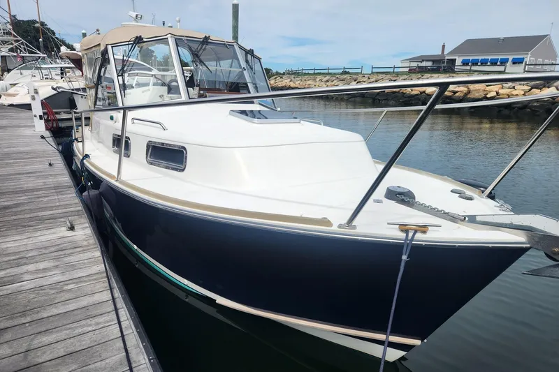 Slide: The Image of 2004 Legacy 28ft boat docked at marina, featuring sleek design and spacious cabin. - 3