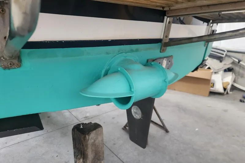 Slide: The Image of 2004 Legacy 28ft boat stern with turquoise hull and propeller housing. - 30