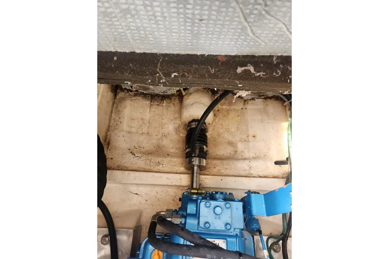 Slide: The Image of Engine compartment of a 2004 Legacy 28ft boat, featuring mechanical components and wiring. - 36