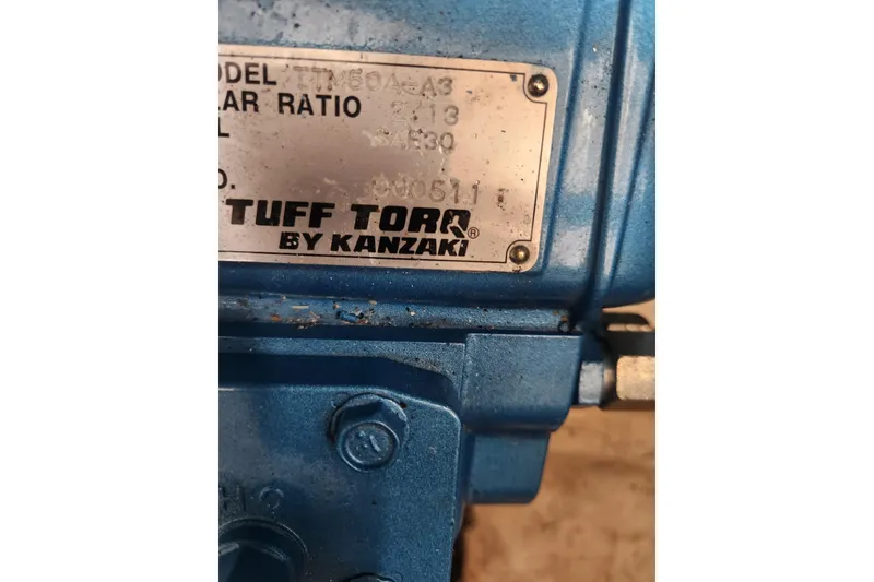 Slide: The Image of Close-up of a Tuff Torq by Kanzaki label on blue machinery. - 45