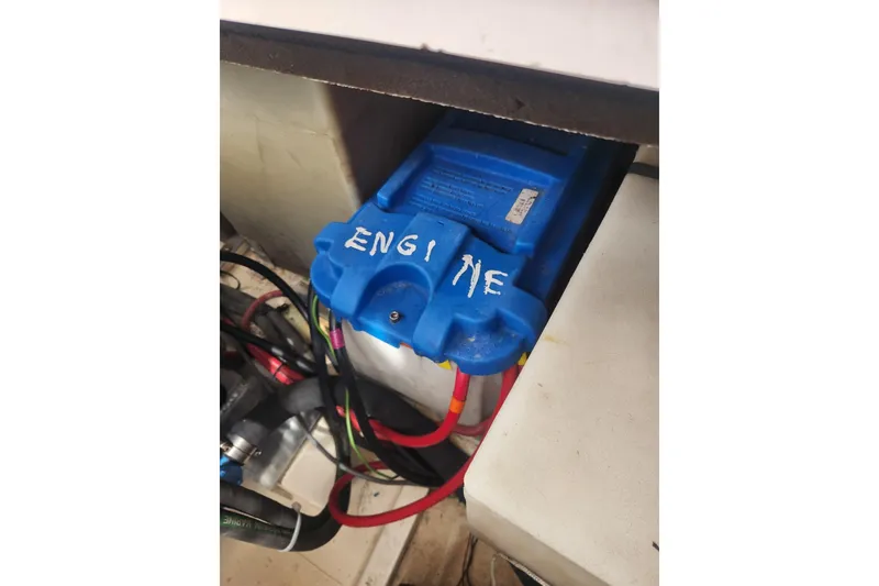 Slide: The Image of Blue engine battery with cables in a 2004 Legacy 28ft boat. - 49