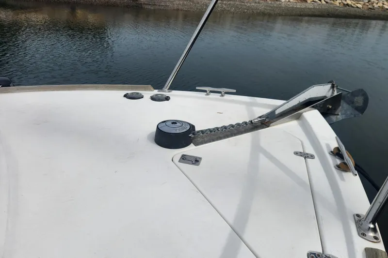Slide: The Image of Bow of 2004 Legacy 28ft boat with anchor chain on calm water. - 6