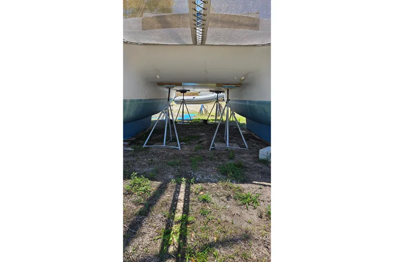 Slide: The Image of Underneath view of a 1996 PDQ 32 LRC catamaran on stands. - 11