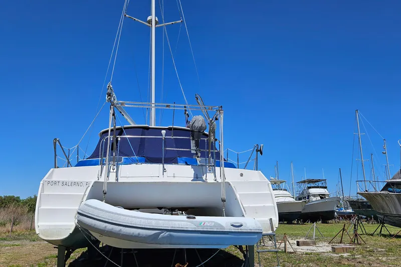 Slide: The Image of 1996 PDQ 32 LRC catamaran on land, Port Salerno, Florida, under clear blue sky. - 14