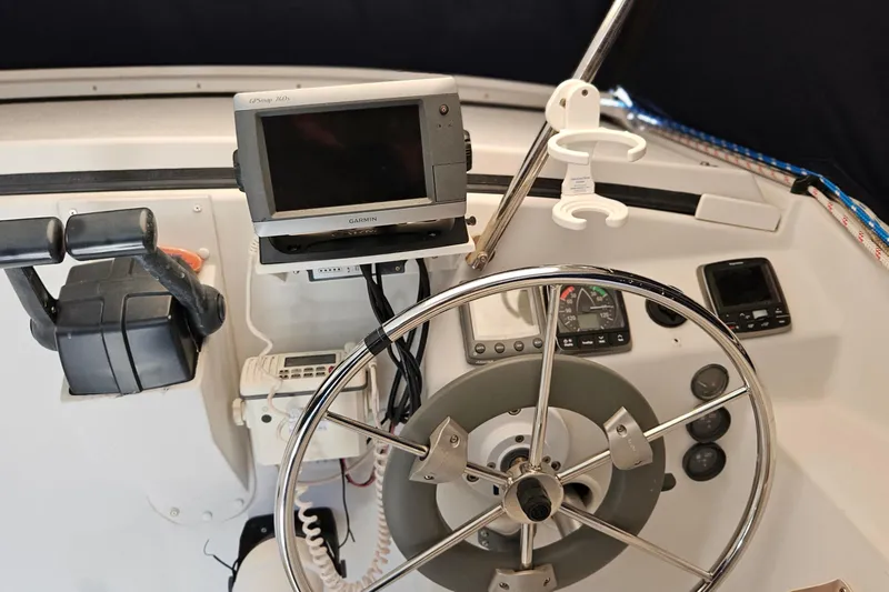 Slide: The Image of Steering console of a 1996 PDQ 32 LRC boat with navigation equipment. - 19