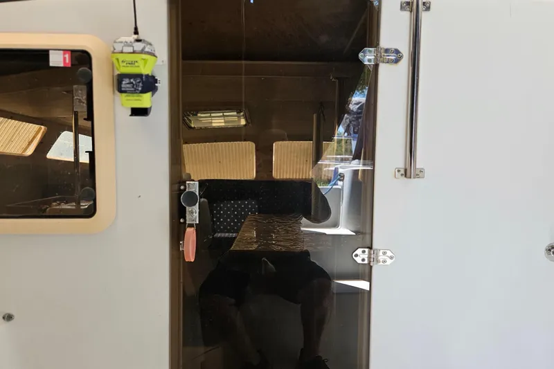 Slide: The Image of Interior view of a 1996 PDQ 32 LRC boat cabin with reflective glass door. - 20