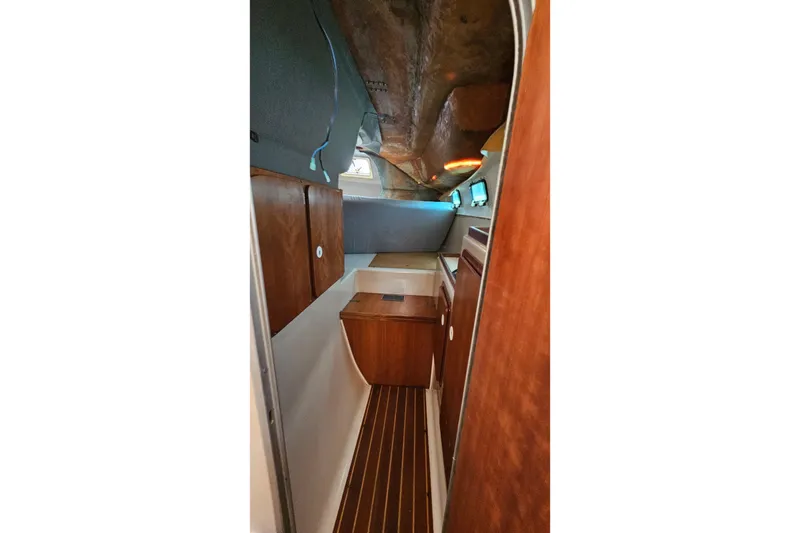 Slide: The Image of Interior of 1996 PDQ 32 LRC boat with wooden cabinetry and compact design. - 24