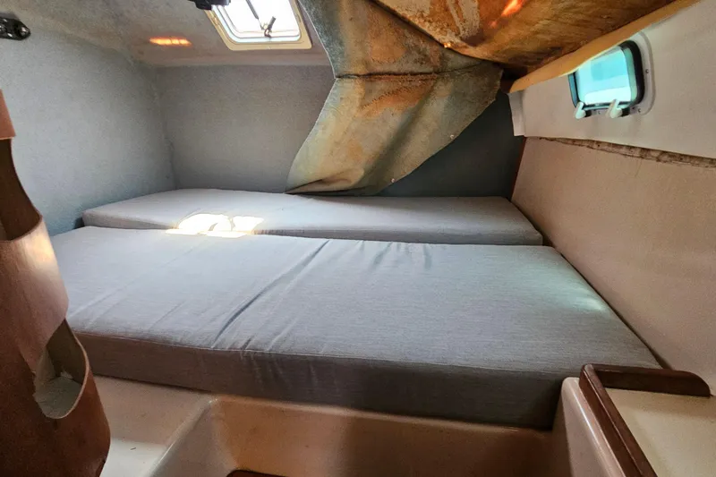 Slide: The Image of Interior cabin of a 1996 PDQ 32 LRC boat with twin beds and a window. - 25