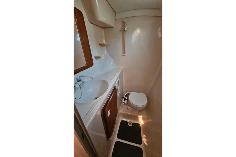 Slide: The Image of Compact bathroom in 1996 PDQ 32 LRC boat with sink, toilet, and mirror. - 30
