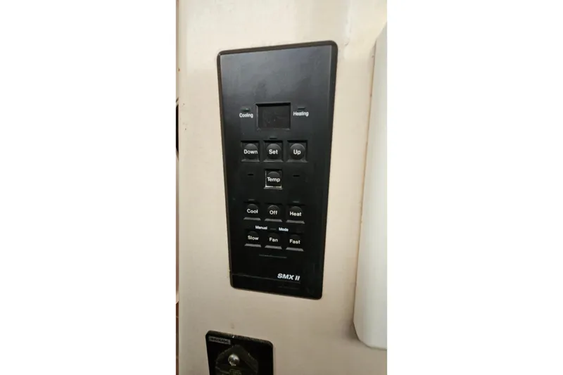 Slide: The Image of Control panel of a 1996 PDQ 32 LRC boat, featuring temperature and fan settings. - 31
