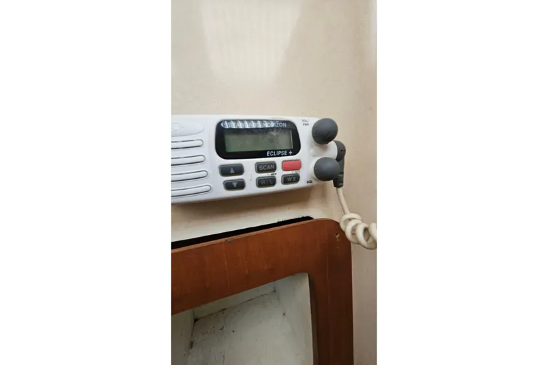 Slide: The Image of VHF radio on PDQ 32 LRC boat, 1996 model, mounted on a beige wall. - 32