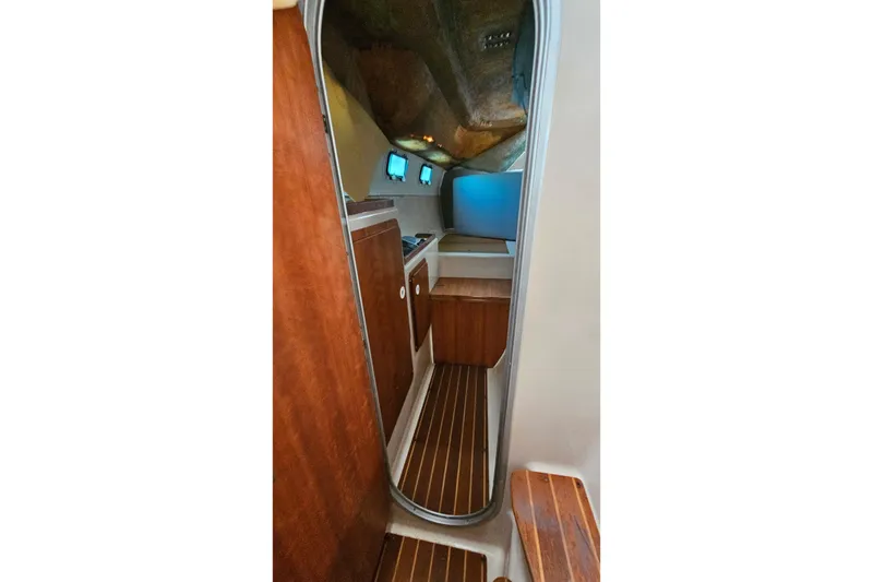 Slide: The Image of Interior of 1996 PDQ 32 LRC boat with wooden cabinetry and flooring. - 33