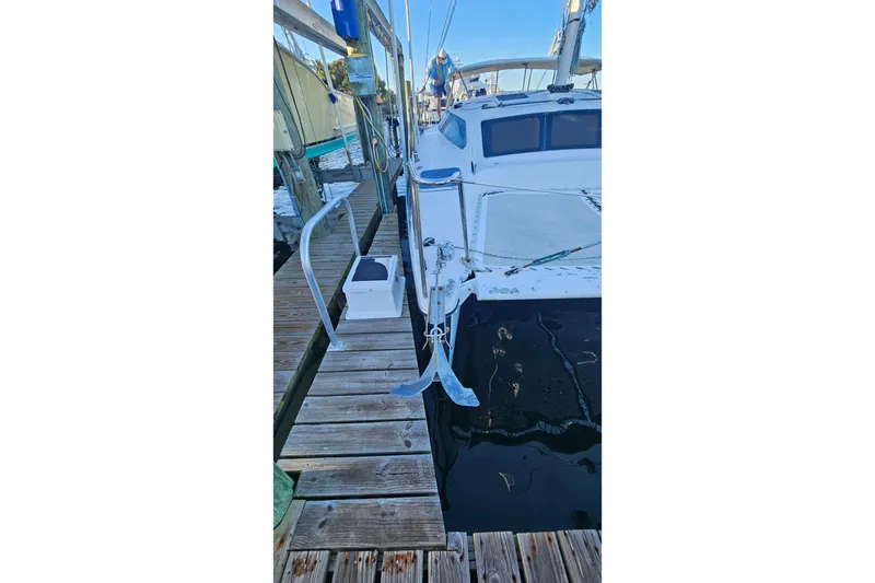 Slide: The Image of Docked 1996 PDQ 32 LRC catamaran with visible anchor and deck details. - 4