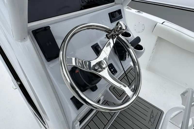 Slide: The Image of Steering wheel of 2026 Tidewater 232 CC Adventure boat, featuring modern controls and sleek design. - 11