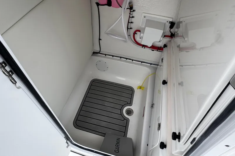 Slide: The Image of Interior view of 2026 Tidewater 232 CC Adventure boat compartment with equipment. - 12