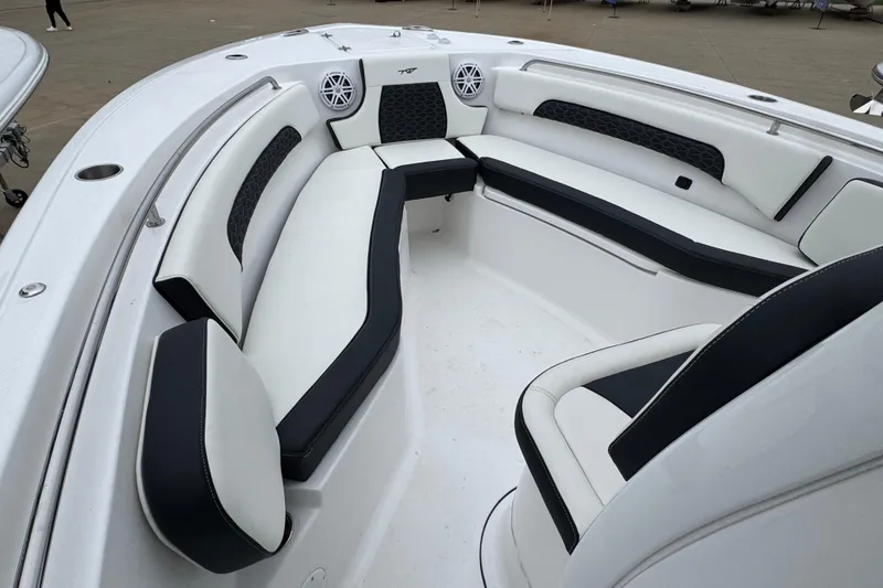 Slide: The Image of 2026 Tidewater 232 CC Adventure boat interior with cushioned seating and modern design. - 13