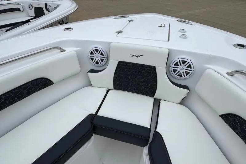 Slide: The Image of 2026 Tidewater 232 CC Adventure boat interior with cushioned seating and speakers. - 15
