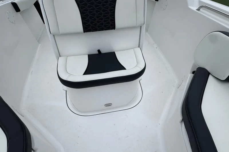 Slide: The Image of Interior seating of 2026 Tidewater 232 CC Adventure boat, featuring white and black upholstery. - 16