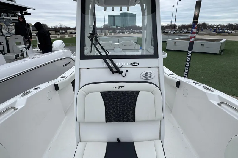 Slide: The Image of 2026 Tidewater 232 CC Adventure boat interior with seating and console view. - 17