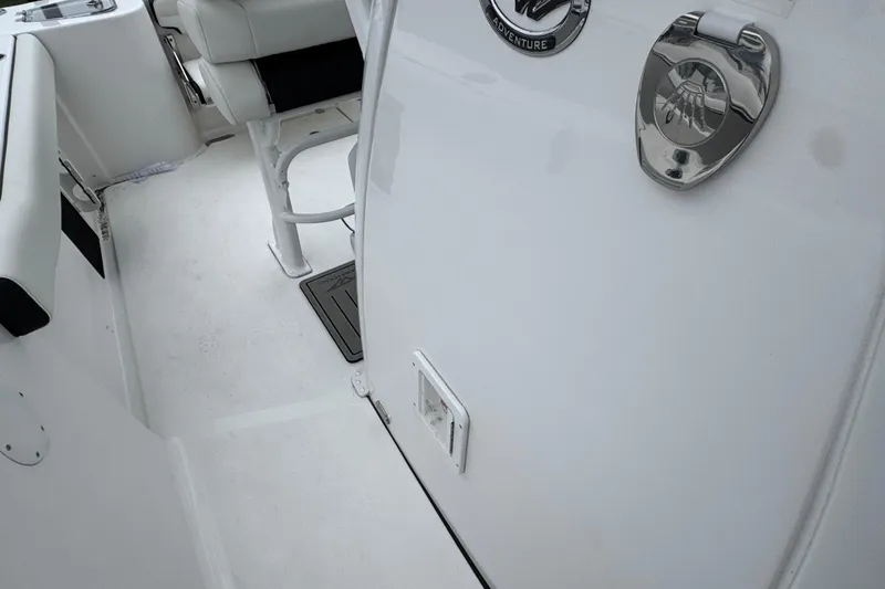 Slide: The Image of 2026 Tidewater 232 CC Adventure boat interior with seating and chrome details. - 18