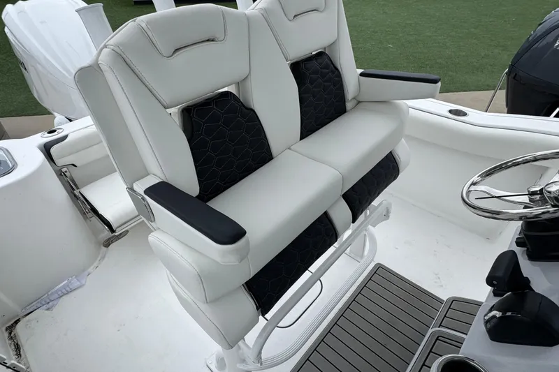 Slide: The Image of 2026 Tidewater 232 CC Adventure boat seating and helm with modern design. - 19